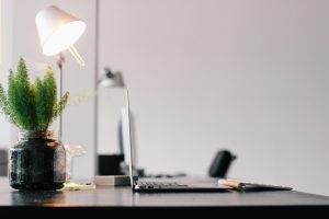 an office desk with a laptop on it.